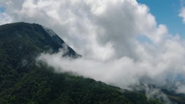 Camiguin Adası 'ndaki uçurum ve ormanla kaplı bulutların drone görüntüsü. Filipinler.