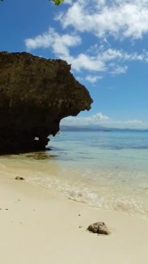 Okyanus dalgalı tropik plaj. Sohoton Koyu. Socorro, Surigao del Norte. Filipinler. Dikey görünüm.