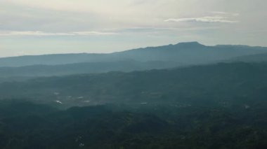 Yoğun orman ve bulutlarla kaplı tropik dağ tepelerinin hava manzarası. Mindanao, Filipinler.