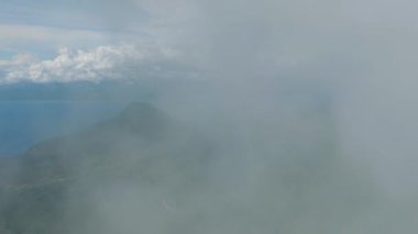 Dağların yamaçlarında mavi gökyüzü ve bulutlar. Camiguin Adası. Filipinler.