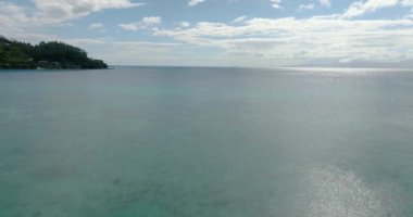 Mercanlı turkuaz deniz suyuna güneş yansıması. Mavi gökyüzü ve bulutlar. Romblon, Filipinler.