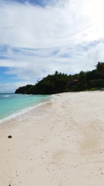 Tropik sahilde kristal berrak okyanus dalgaları. Romblon, Filipinler 'deki Carabao Adası. Dikey görünüm.