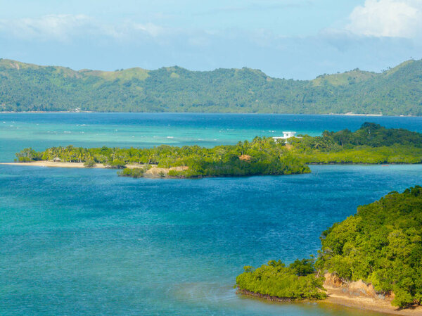 Cabangajan Island with ocean waves and mangroves. Santa Fe, Tablas, Romblon. Philippines.