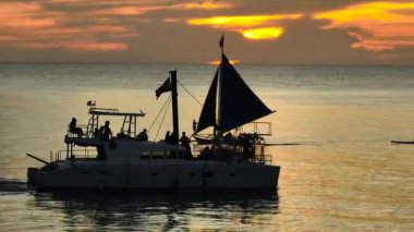 Boracay, Filipinler 'deki turist teknelerinin üzerinde büyüleyici günbatımı ve gökyüzü.