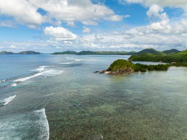 Okyanus dalgalarıyla adanın drone görüntüsü. Busuanga, Palawan 'da saydam deniz suyu. Filipinler.