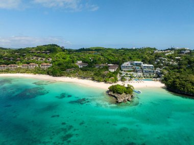 Beyaz kumlu sahilde, deniz dalgaları ve berrak sularıyla hindistan cevizi ağaçları. Punta Bunga Sahili. Boracay, Filipinler.