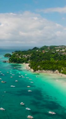 Şeffaf deniz suyu ve kumlu kıyı şeridi üzerinde tekneler. Boracay Adası. Filipinler. Dikey görünüm.