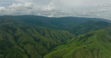 Güzel dağ tepeleri ve yeşil bitki örtüsü. Mavi gökyüzü ve bulutlar. Mindanao, Filipinler.