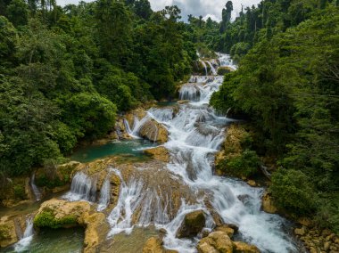 Aliwagwag Falls surrounded by tropical forest. Mindanao, Philippines. clipart