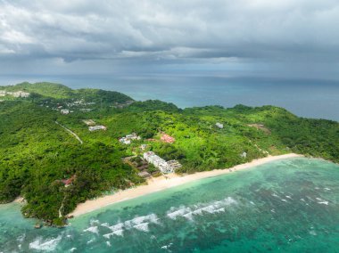 Drone view of beach resorts with ocean waves and white sand. Ilig Iligan Beach. Boracay, Philippines. clipart