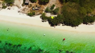 Açık turkuaz deniz suyunun üzerinde güneş ışığı yansımasıyla uçuyor. Bantayan Adası 'ndaki plajlar. Cebu, Filipinler.