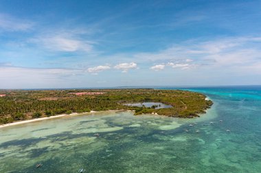 Fishing boats over turquoise sea water with corals. Tropical island with white sandy beaches. Blue sky and clouds. Bantayan Island. Cebu, Philippines. clipart