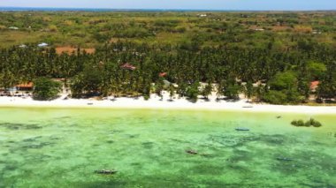 Tropical coral reefs and white sands in beaches in Bantayan Island. Fishing boats floating over turquoise sea water. Cebu, Philippines.