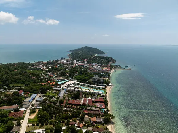 Sahil köyü, arka planda tepeler ve kıyı şeridi boyunca turkuaz deniz olan yeşilliklerle çevrili. Ko Pha Ngan, Tayland.