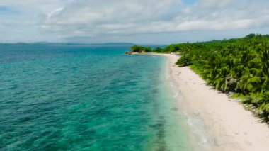 Beyaz kumsal manzarası ve turkuaz sularda görünen mercanlar. San Jose, Romblon, Filipinler.