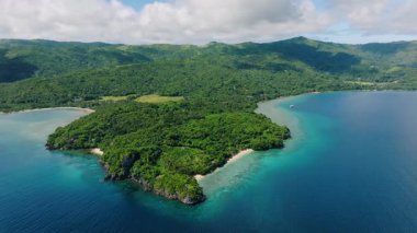 Sahil şeridi boyunca tropikal ormanlar, mavi deniz ve tepeler olan bir manzara. Romblon, Filipinler.