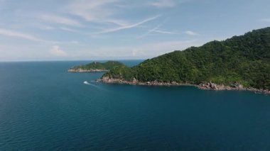 Derin mavi deniz ve dağınık bulutlarla çevrili yemyeşil tepeleri olan adalar zinciri. Koh Tao, Tayland.
