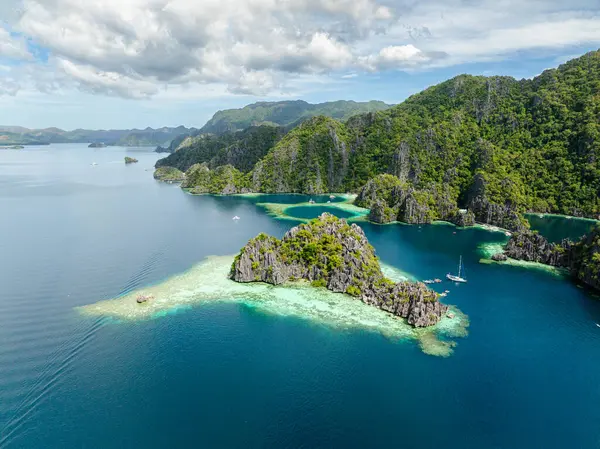 Mavi denizi aşan bir turist teknesi. Coron, Palawan 'da ikiz göl. Filipinler.