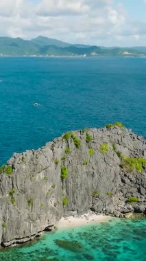 Miniloc Adası 'ndaki İkiz Kayalıklar' ın etrafında dolaşan tekneler. El Nido, Filipinler. Palawan 'da. Dikey görünüm.