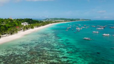 Aerial view of a lush tropical island surrounded by stunning beaches and azure waters. Boracay Island, Philippines.