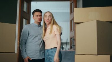 Kiralık dairede oturan neşeli kiracılar iç mekâna bakıyor. Genç ve mutlu bir aile, paketlenmiş karton kutularla dolu daireye giriyor. Güzel ev sahipleri gülümsüyor İpotek evine taşınıyor.