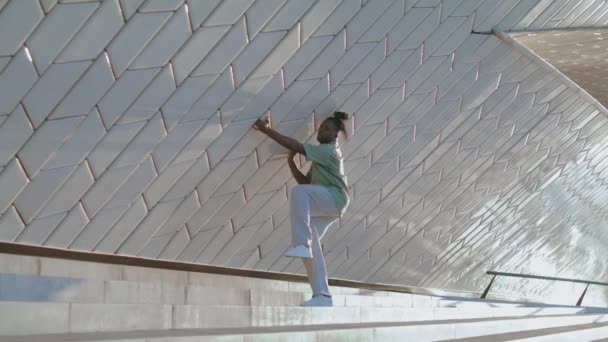 富有创意的人独自在体育馆里有节奏地跳舞 做当代爵士舞的黑人发人在现代区级楼梯上跳舞 非裔美国人专业即兴表演 表现出不同的技巧 — 图库视频影像