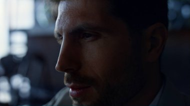 Serious man looking mobile phone in private house portrait. Tired businessman watching smartphone in dark luxury hotel. Worried manager hands holding device waiting office closeup. Depression concept