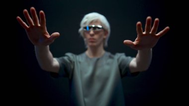 Man working inside metaverse in virtual reality world. Creative male in headset looking hands touching invisible objects. Person vr goggles experience futuristic social media concepts slow motion