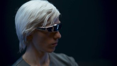 Blonde gamer playing metaverse nft in 3d glasses closeup. Smart man typing surrounded with futuristic invisible interface 3d data black background. Augmented reality, future technology concept