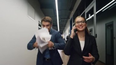 Neşeli ortaklar başarılı paylaşım haberlerini kutluyorlar. Mutlu adam kağıtları fırlatıyor. Müşteri sözleşmesi için heyecanlanıyor. Gülümseyen iş kadını yöneticiyle cep telefonu konuşması. Kurumsal zafer kavramı