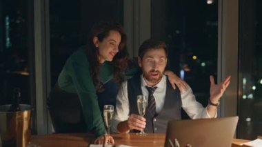 Mutlu kahkahalar atan iş ortakları. Pazarlık kazanma konusunda heyecanlı. Başarılı finansal yatırım. Birkaç iş arkadaşı laptopta iyi haberler okuyarak zafere seviniyor..