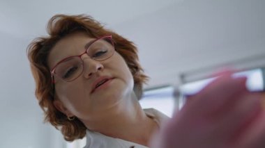 Kadın güzellik uzmanı, yüz gerdirme operasyonu için bilinmeyen bir müşteriyi yüz gerdirme ameliyatına hazırlıyor. Profesyonel estetik cerrah yenilenme ameliyatından önce yüz hatları çiziyor. Kozmetoloji kliniği prosedürü.