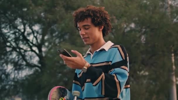 Involved Student Crossing Street Sunset Closeup Skater Guy Hiding Smartphone — Stock video