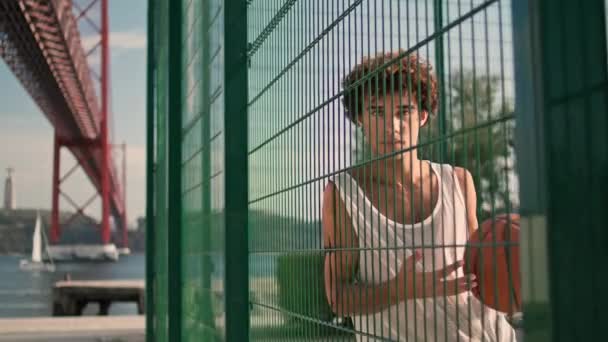 Curly Teenager Posing Metal Grid Portrait Basketball Player Looking Camera — Stock video