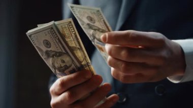 Man hands calculating dollar banknotes denomination of hundred close up. Unknown rich successful businessman counting money cash business profit. Male fingers holding pack of american currency.