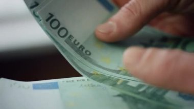 Cashier hands counting money euro cash close up. Unknown man keep lot of bills european currency indoors. Male fingers holding hundreds banknotes. Employee salary business profit bank loan concept.