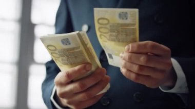 Pack euro bills counting by unknown successful business man close up. Male hands calculating paper banknotes european currency denomination of two hundred. Financial income profit investment concept.