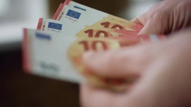 Man hands counting small savings indoors close up. Unknown young worker calculating euro bills for bank deposit purchase payment. Male fingers holding banknotes european currency. Money cash concept.