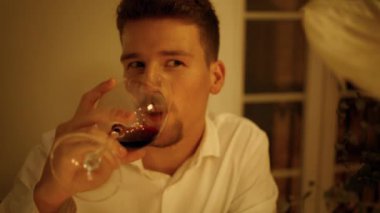 Yakışıklı adam romantik randevu odasında şarap tadıyor. Akşam yemeğinde alkol alan traşsız bir adam. Elinde cam bardak olan gülümseyen bir beyefendi karşılıklı portre dinliyor. Yıldönümü kavramı