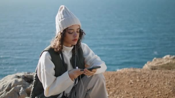 Pretty Girl Listening Online Music Ocean Cliff Serene Woman Relaxing — Vídeos de Stock
