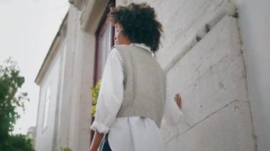Gorgeous fashion woman posing in front old building sunny day. Attractive stylish african american model standing cozy city street alone. Young confident girl enjoy weekend outdoors. Leisure concept.