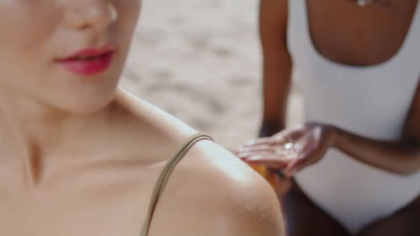 Closeup Hands Applying Suntan Cream Shoulder Multiethnic Girlfriends Sunbath Resting — Stock video