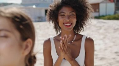 Smiling girl enjoying beach with lgbt partner closeup. Happy african american adjusting touching black curly hair. Joyful stylish woman enjoy summer weekend at ocean shore. Coastline holiday concept