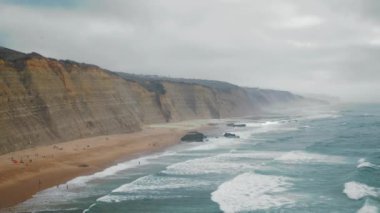 Stormy sea splashing landscape background. Dark ocean waves breaking in nature view. Winter dusk water surface in dramatic skyline clouds. Storm thunder in evening beach outside. Scenic concept