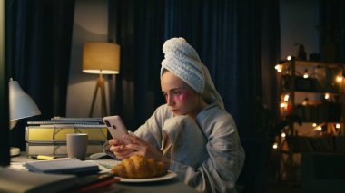 Evde akıllı telefon okuyan sıkıcı bir kız var. Bilgisayar masasında mobil ekran izleyen ciddi bir kadın. Uzaktan çalışan serbest çalışan sosyal medya mesajlarını kontrol ediyor. Gece hayatı konsepti 