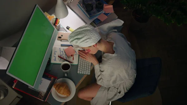 Calm lady napping home in bathrobe closeup. Workaholic freelancer enjoying dream top view. Tired girl taking break sleeping at remote workplace. Sleepy woman looking smartphone checking time