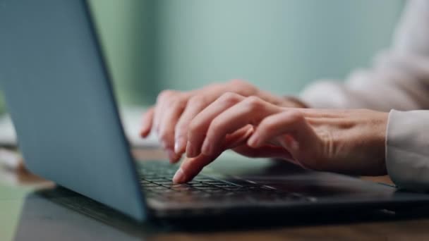 オフィスのクローズアップで女性の手のテキストメッセージノートパソコンのキーボード キャビネットの職場で電子メールを書いている無名の実業家 プレスリリースの準備ボタンを押す創造的なコピーライターの指 — ストック動画