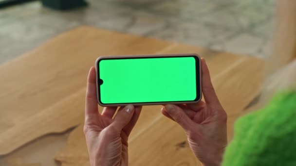 女商人手拿着模拟智能手机在室内 用彩色屏幕显示手机挡住不明身份的女士 匿名妇女观看水平绿色显示电话在线放大 技术概念 — 图库视频影像