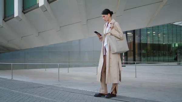 Confident Young Woman Reading Sms Street Wearing Elegant Coat Attractive — стоковое фото