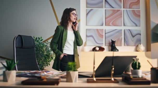 자신있는 사업가가 사무실에 서라고 스마트폰 응답을 매력적 성공적 직장에서 핸드폰을 — 비디오
